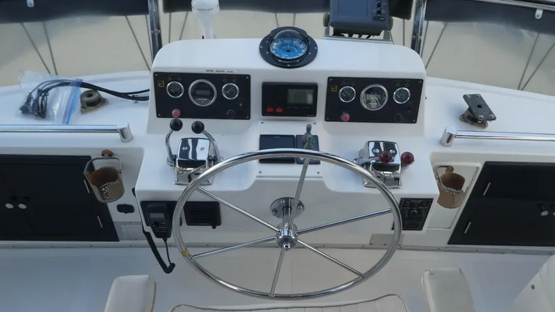 Slide: The Image of 1993 Ocean Alexander 440 Sundeck CPMY helm with steering wheel and navigation instruments. - 10