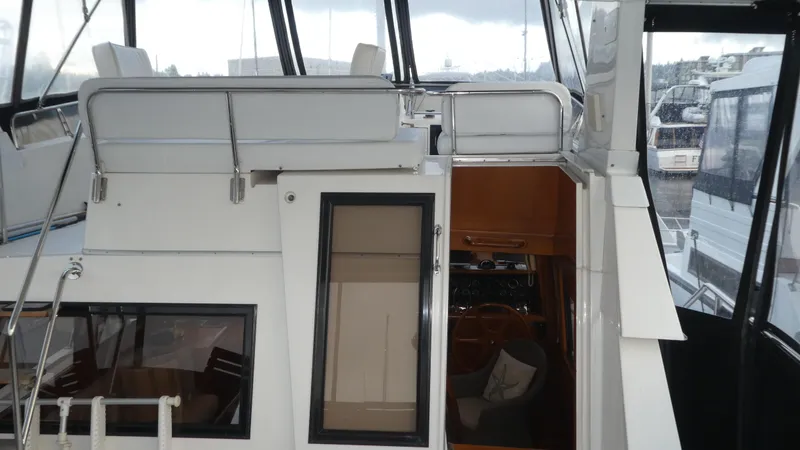 Slide: The Image of 1993 Ocean Alexander 440 Sundeck CPMY yacht interior view with seating and windows. - 12