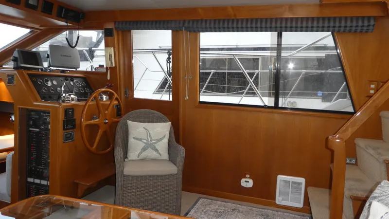 Slide: The Image of 1993 Ocean Alexander 440 Sundeck CPMY interior with helm, wicker chair, and starfish pillow. - 15