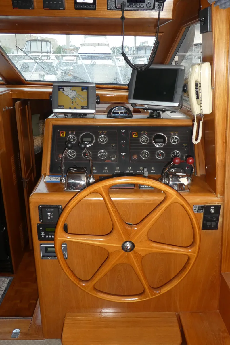 Slide: The Image of 1993 Ocean Alexander 440 Sundeck CPMY helm with wooden wheel and navigation instruments. - 16