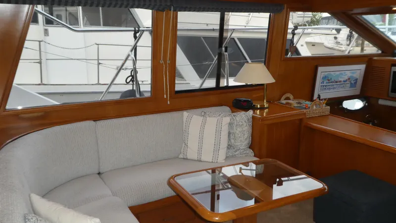 Slide: The Image of Interior of 1993 Ocean Alexander 440 Sundeck CPMY with cozy seating and wooden accents. - 18