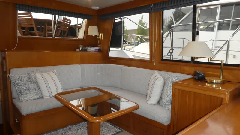 Slide: The Image of Interior of 1993 Ocean Alexander 440 Sundeck CPMY with cozy seating and wooden accents. - 19