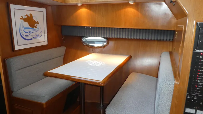 Slide: The Image of Cozy dining area in 1993 Ocean Alexander 440 Sundeck CPMY yacht with wood finish and seating. - 21