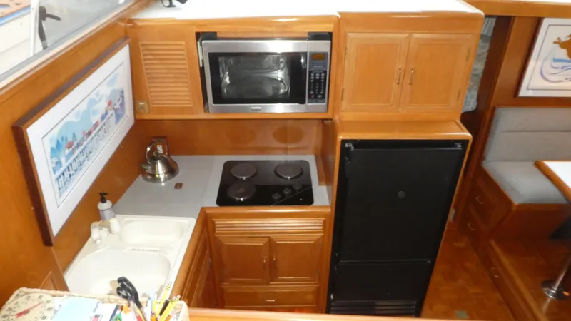 Slide: The Image of 1993 Ocean Alexander 440 Sundeck CPMY galley with microwave, stove, and refrigerator. - 22