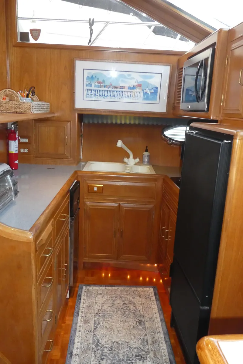 Slide: The Image of 1993 Ocean Alexander 440 Sundeck CPMY kitchen with wood cabinetry and modern appliances. - 25