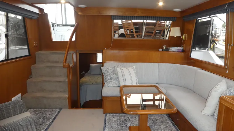 Slide: The Image of Interior of 1993 Ocean Alexander 440 Sundeck CPMY with cozy seating and wooden accents. - 27