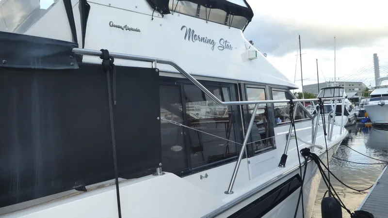 Slide: The Image of 1993 Ocean Alexander 440 Sundeck CPMY docked, featuring sleek design and spacious deck. - 3