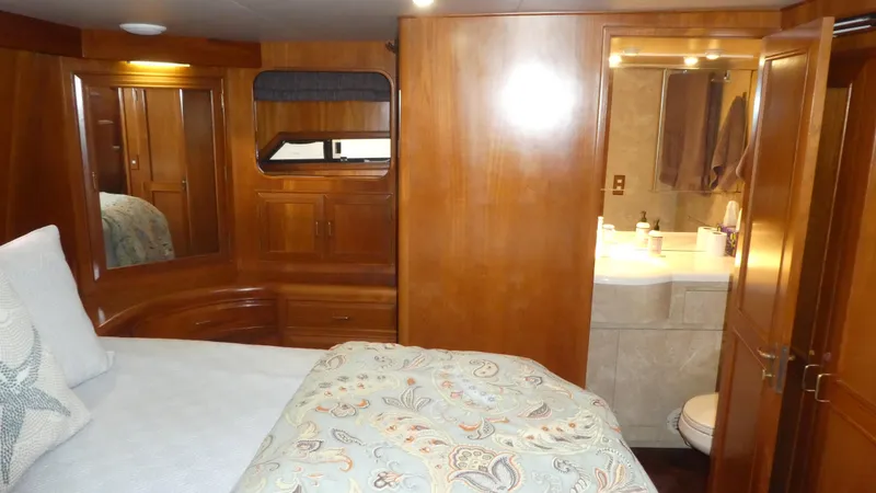 Slide: The Image of Luxurious 1993 Ocean Alexander 440 Sundeck CPMY cabin with wood paneling and ensuite bathroom. - 30
