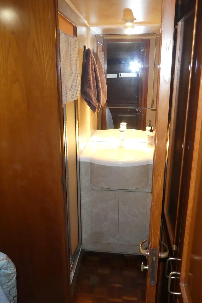 Slide: The Image of Bathroom interior of 1993 Ocean Alexander 440 Sundeck CPMY yacht, featuring wooden finishes and a sink. - 31