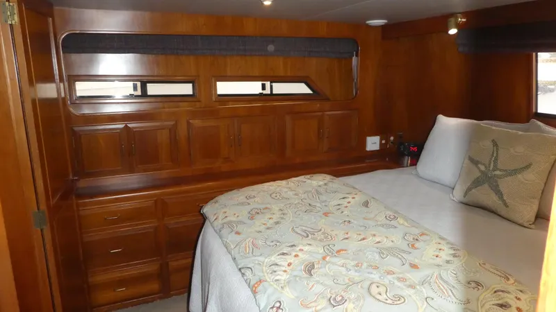 Slide: The Image of 1993 Ocean Alexander 440 Sundeck CPMY cabin with wooden cabinetry and cozy bedding. - 33
