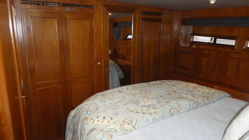 Slide: The Image of Luxurious 1993 Ocean Alexander 440 Sundeck CPMY cabin with wood paneling and cozy bedding. - 34