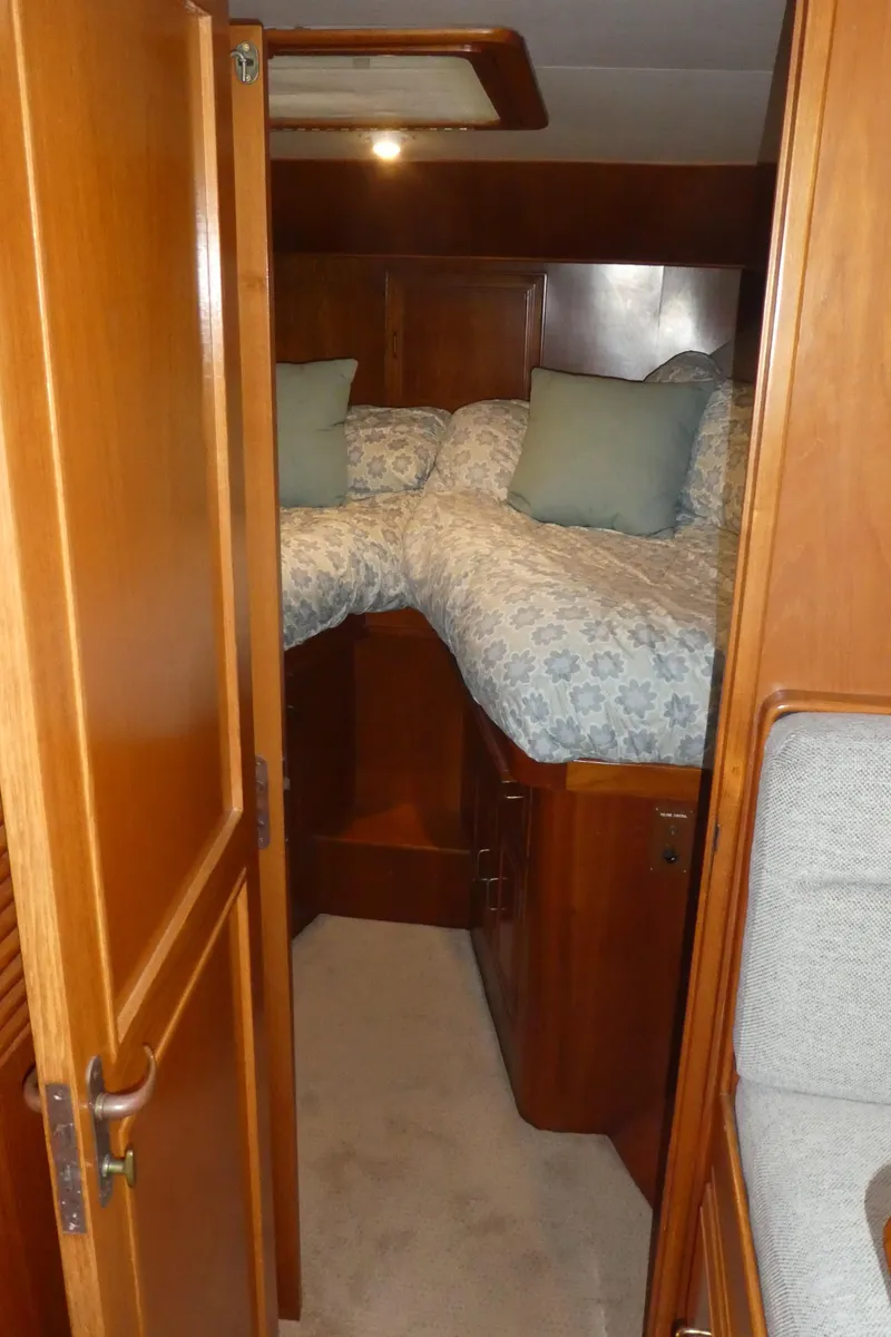 Slide: The Image of 1993 Ocean Alexander 440 Sundeck CPMY cabin with cozy twin beds and wooden interior. - 36