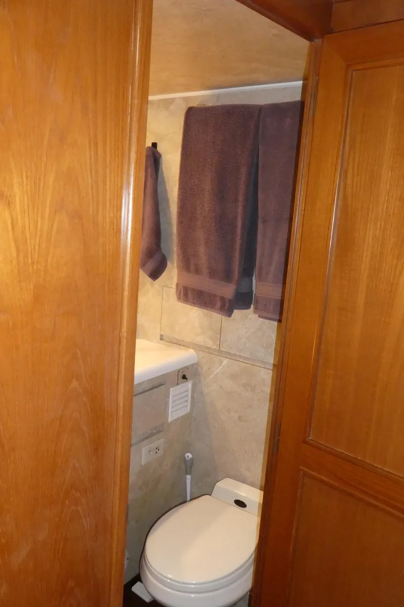 Slide: The Image of Bathroom interior of 1993 Ocean Alexander 440 Sundeck CPMY yacht with wooden door and towels. - 37