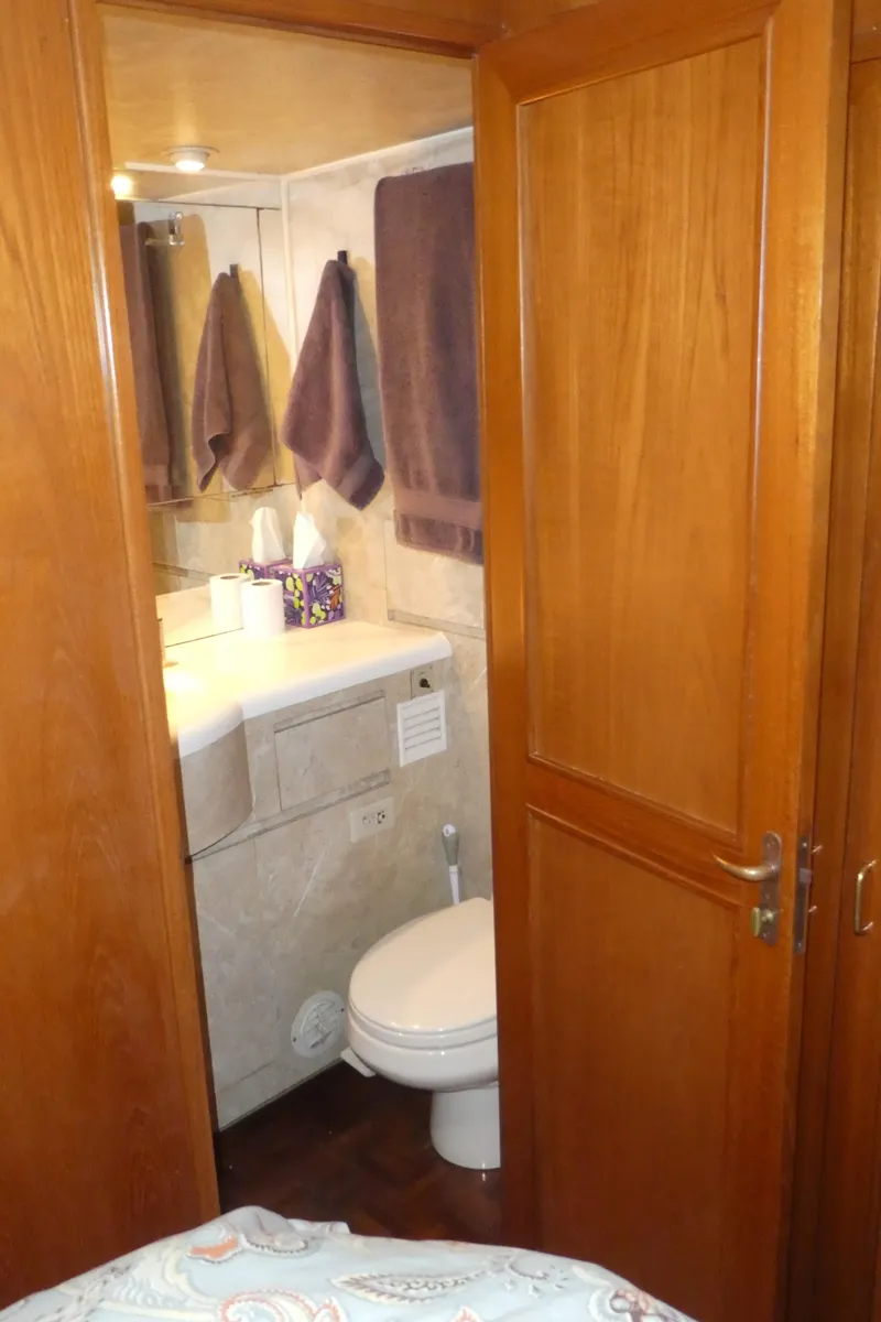 Slide: The Image of Bathroom interior of 1993 Ocean Alexander 440 Sundeck CPMY yacht, featuring wooden door and modern amenities. - 38