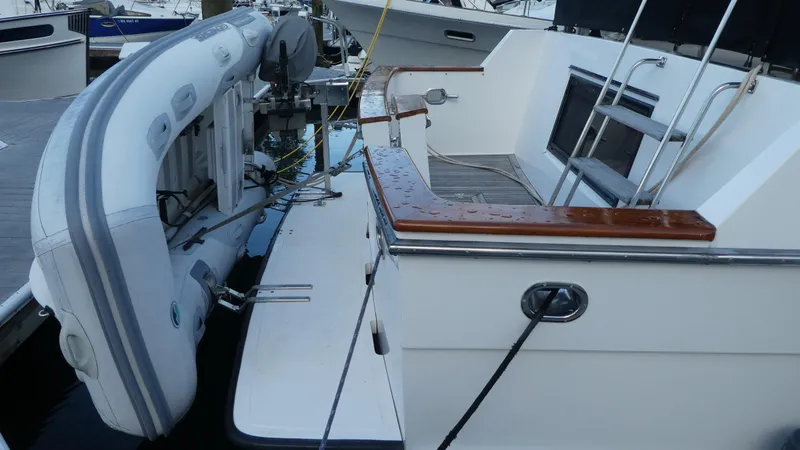 Slide: The Image of 1993 Ocean Alexander 440 Sundeck CPMY with dinghy on deck, docked at marina. - 4