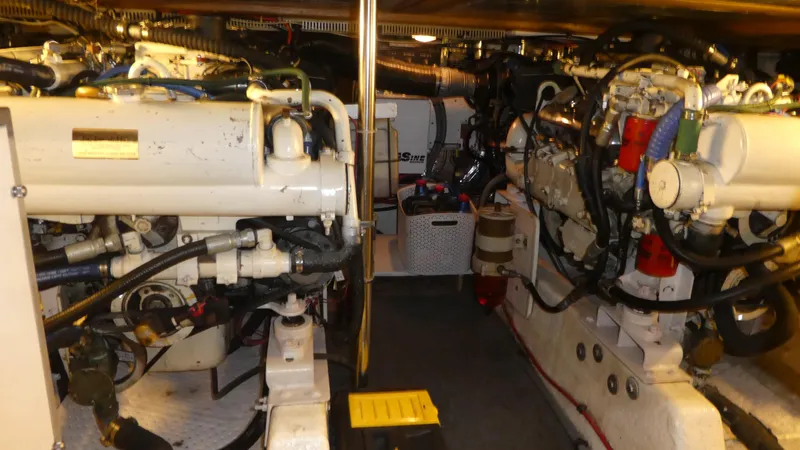 Slide: The Image of Engine room of 1993 Ocean Alexander 440 Sundeck CPMY, showcasing dual engines and mechanical components. - 46