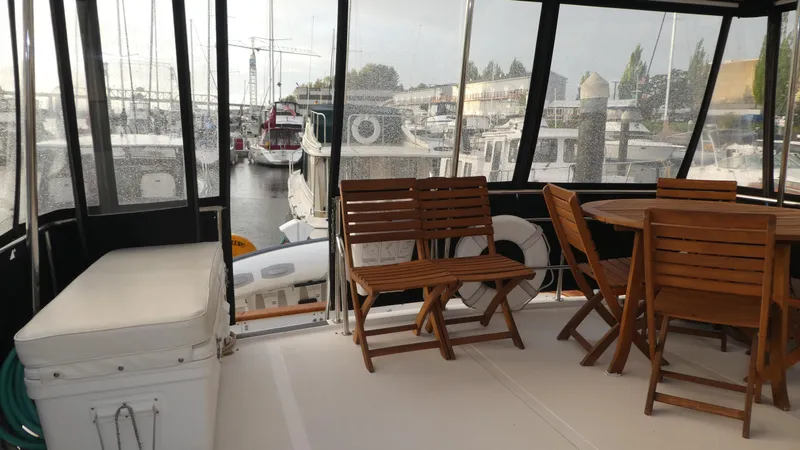 Slide: The Image of 1993 Ocean Alexander 440 Sundeck CPMY with wooden deck furniture in marina setting. - 6