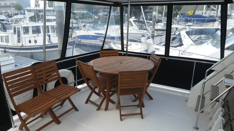 Slide: The Image of 1993 Ocean Alexander 440 Sundeck CPMY with wooden deck furniture, marina view. - 7