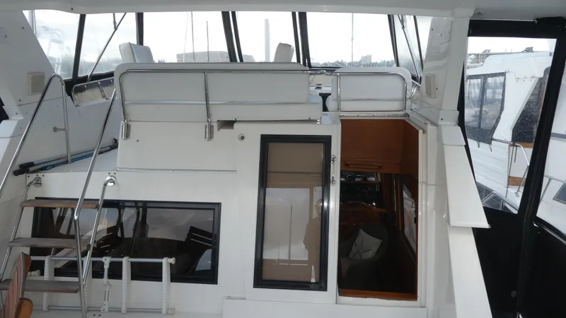 Slide: The Image of 1993 Ocean Alexander 440 Sundeck CPMY yacht interior with seating and stairs. - 8