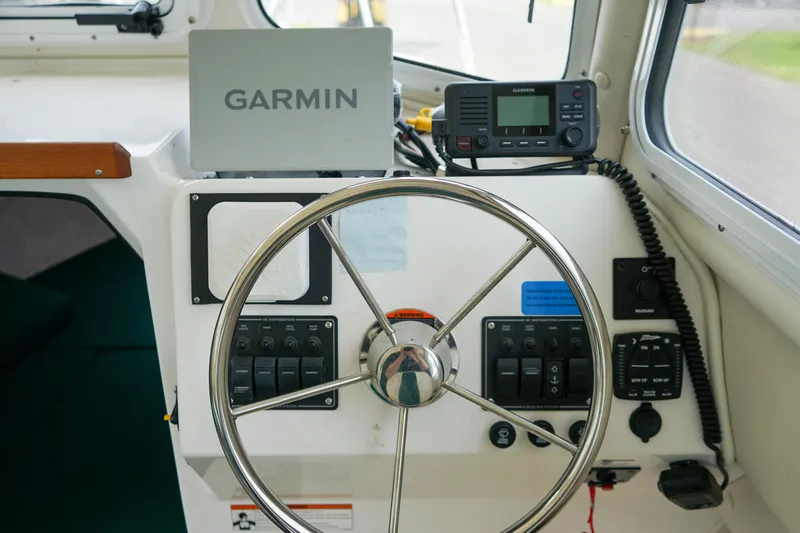 Slide: The Image of Helm of 2021 C-Dory 25' Cruiser with Garmin navigation and radio equipment. - 16