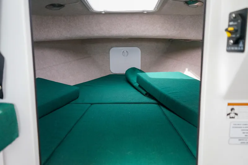 Slide: The Image of Interior cabin of 2021 C-Dory 25' Cruiser with green cushions. - 19
