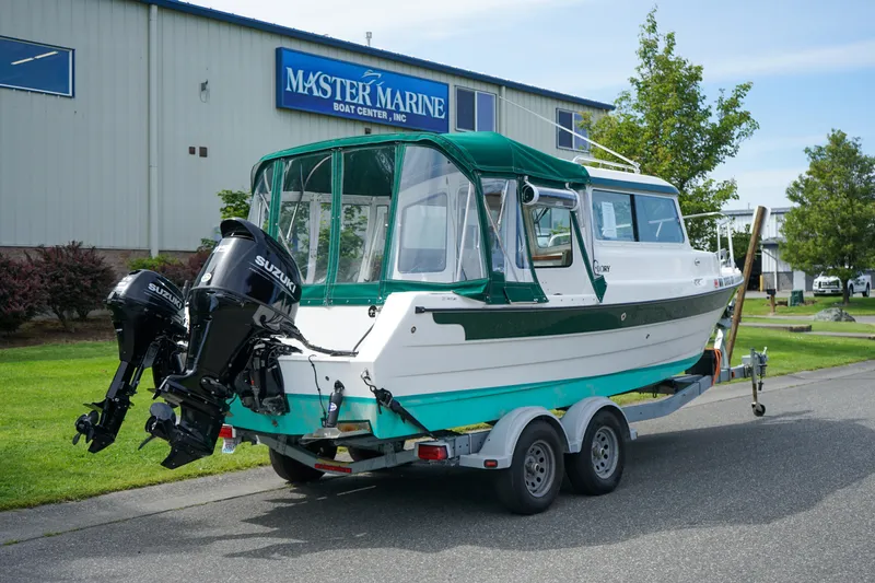 Slide: The Image of 2021 C-Dory 25' Cruiser on trailer outside Master Marine Boat Center. - 3