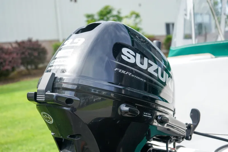 Slide: The Image of Suzuki outboard motor on 2021 C-Dory 25' Cruiser, four-stroke engine, outdoor setting. - 6