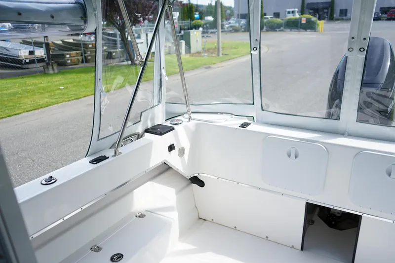 Slide: The Image of 2021 C-Dory 25' Cruiser interior with clean, white seating and clear windows. - 7