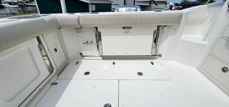 Slide: The Image of 2016 Boston Whaler 285 Conquest boat deck with storage compartments and seating. - 11