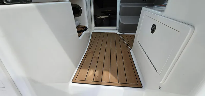 Slide: The Image of 2016 Boston Whaler 285 Conquest interior with teak flooring and storage compartment. - 22