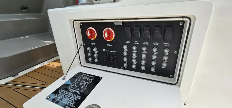 Slide: The Image of Control panel of 2016 Boston Whaler 285 Conquest boat with switches and dials. - 23