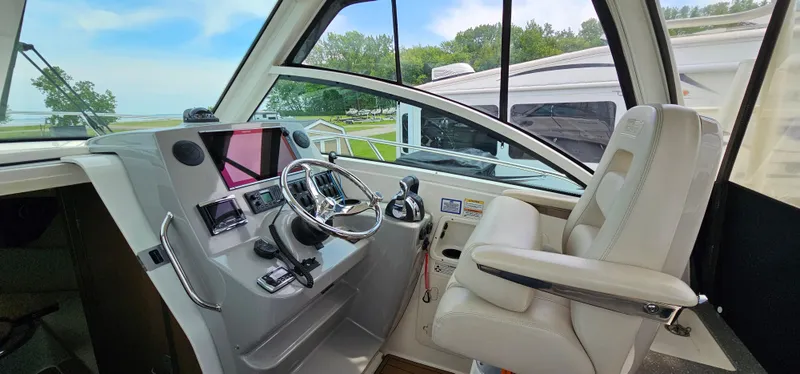 Slide: The Image of 2016 Boston Whaler 285 Conquest helm with modern controls and comfortable seating. - 25