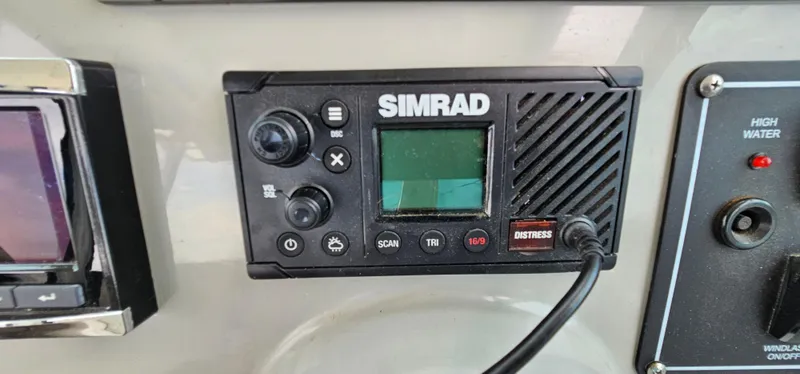 Slide: The Image of Simrad marine radio on 2016 Boston Whaler 285 Conquest dashboard. - 31