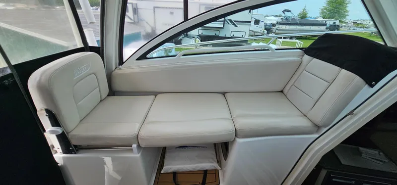 Slide: The Image of 2016 Boston Whaler 285 Conquest interior seating area with white cushions. - 32