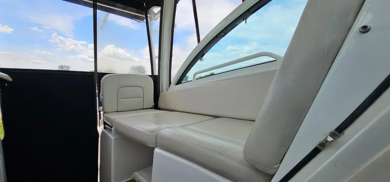 Slide: The Image of 2016 Boston Whaler 285 Conquest interior seating with window view. - 34