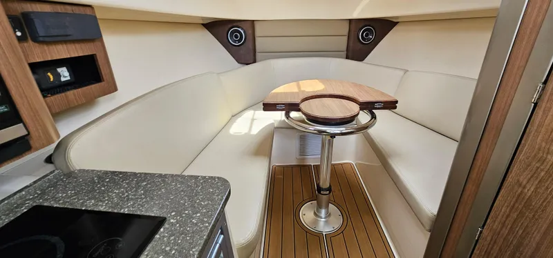 Slide: The Image of 2016 Boston Whaler 285 Conquest cabin interior with seating and table. - 38