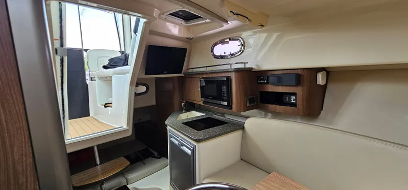 Slide: The Image of Interior of 2016 Boston Whaler 285 Conquest with kitchenette and seating area. - 41