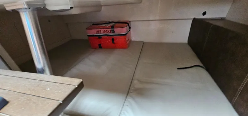 Slide: The Image of 2016 Boston Whaler 285 Conquest cabin interior with life jackets and seating area. - 45
