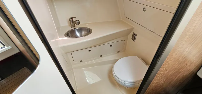 Slide: The Image of 2016 Boston Whaler 285 Conquest boat bathroom with sink and toilet. - 46