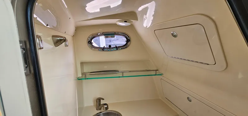 Slide: The Image of Interior cabin of 2016 Boston Whaler 285 Conquest with sink and storage compartments. - 47