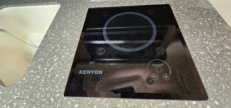 Slide: The Image of Kenyon stove on 2016 Boston Whaler 285 Conquest, set in speckled countertop. - 49