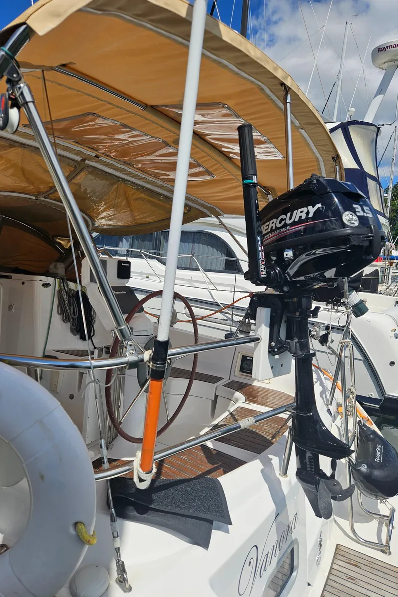 Slide: The Image of 2008 Beneteau 323 sailboat with Mercury outboard motor, docked under sunny skies. - 11