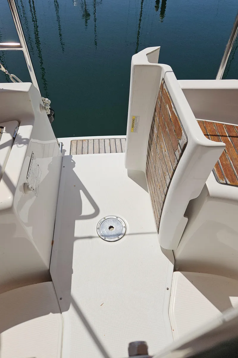 Slide: The Image of 2008 Beneteau 323 yacht deck with wooden accents and water view. - 12