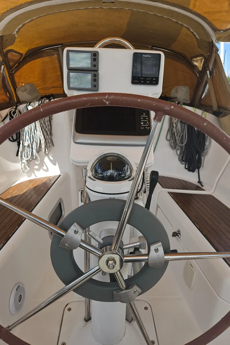 Slide: The Image of Steering wheel and navigation instruments on a 2008 Beneteau 323 sailboat. - 13