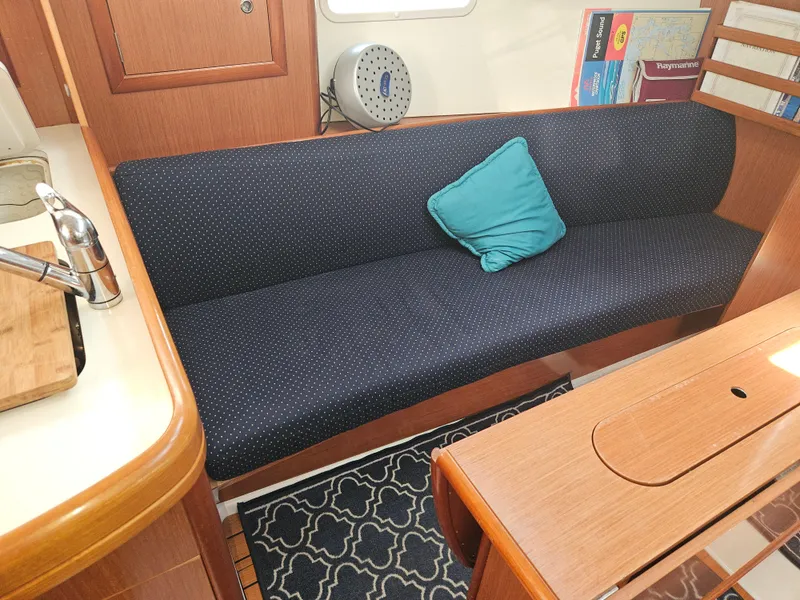 Slide: The Image of Cozy interior of 2008 Beneteau 323 sailboat with blue sofa and teal cushion. - 20