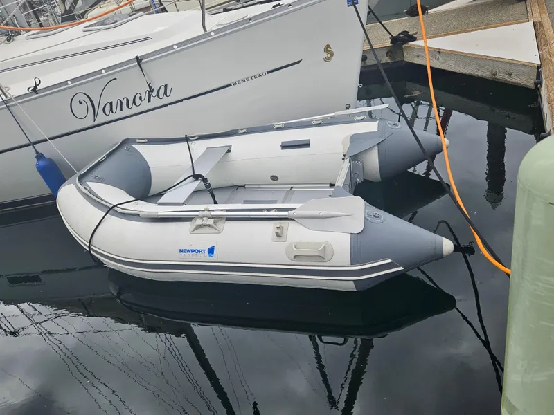 Slide: The Image of Inflatable dinghy docked beside a 2008 Beneteau 323 sailboat. - 27