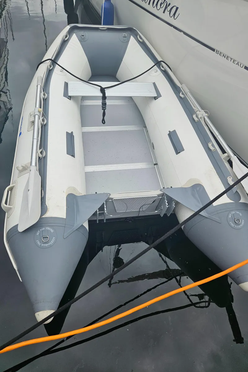 Slide: The Image of Inflatable boat docked beside a 2008 Beneteau 323 yacht. - 28