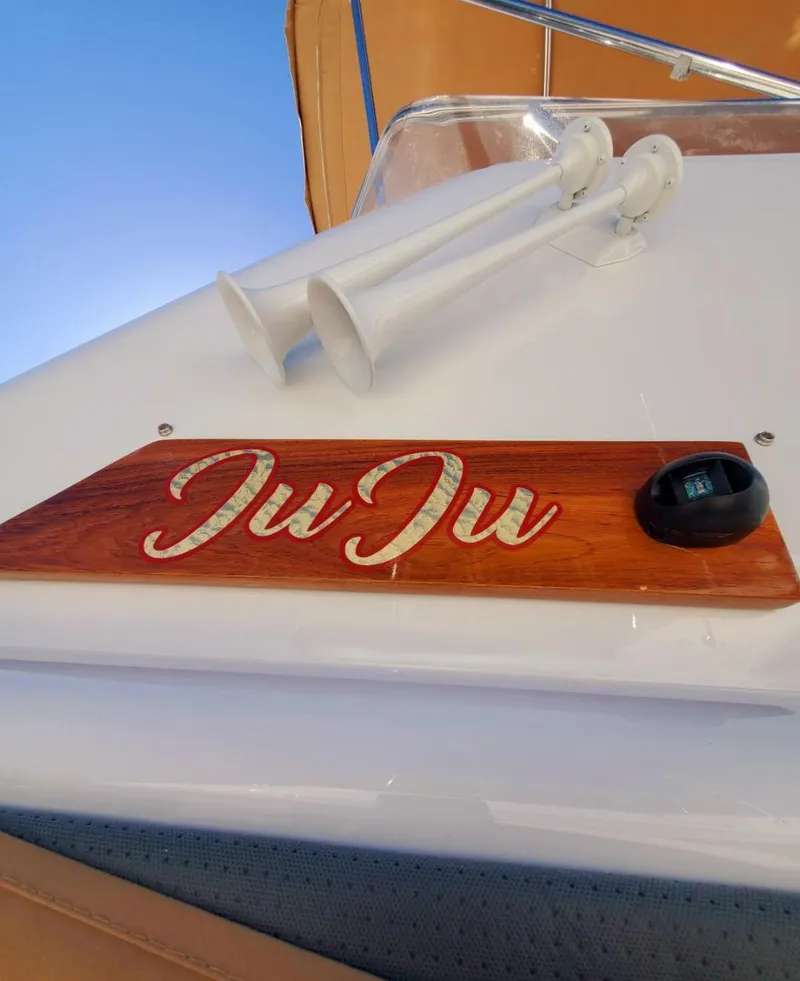 Slide: The Image of 2004 Sabreline 36 Flybridge Fast Trawler with "JuJu" nameplate and dual horns. - 10