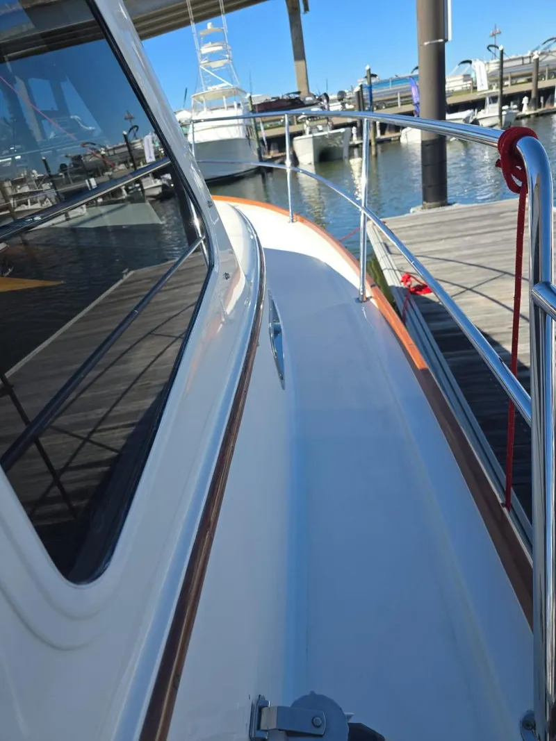 Slide: The Image of 2004 Sabreline 36 Flybridge Fast Trawler docked at marina, side deck view. - 12