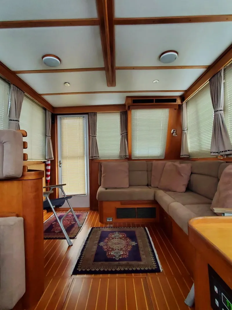 Slide: The Image of Interior of 2004 Sabreline 36 Flybridge Fast Trawler with cozy seating and elegant wood finish. - 17